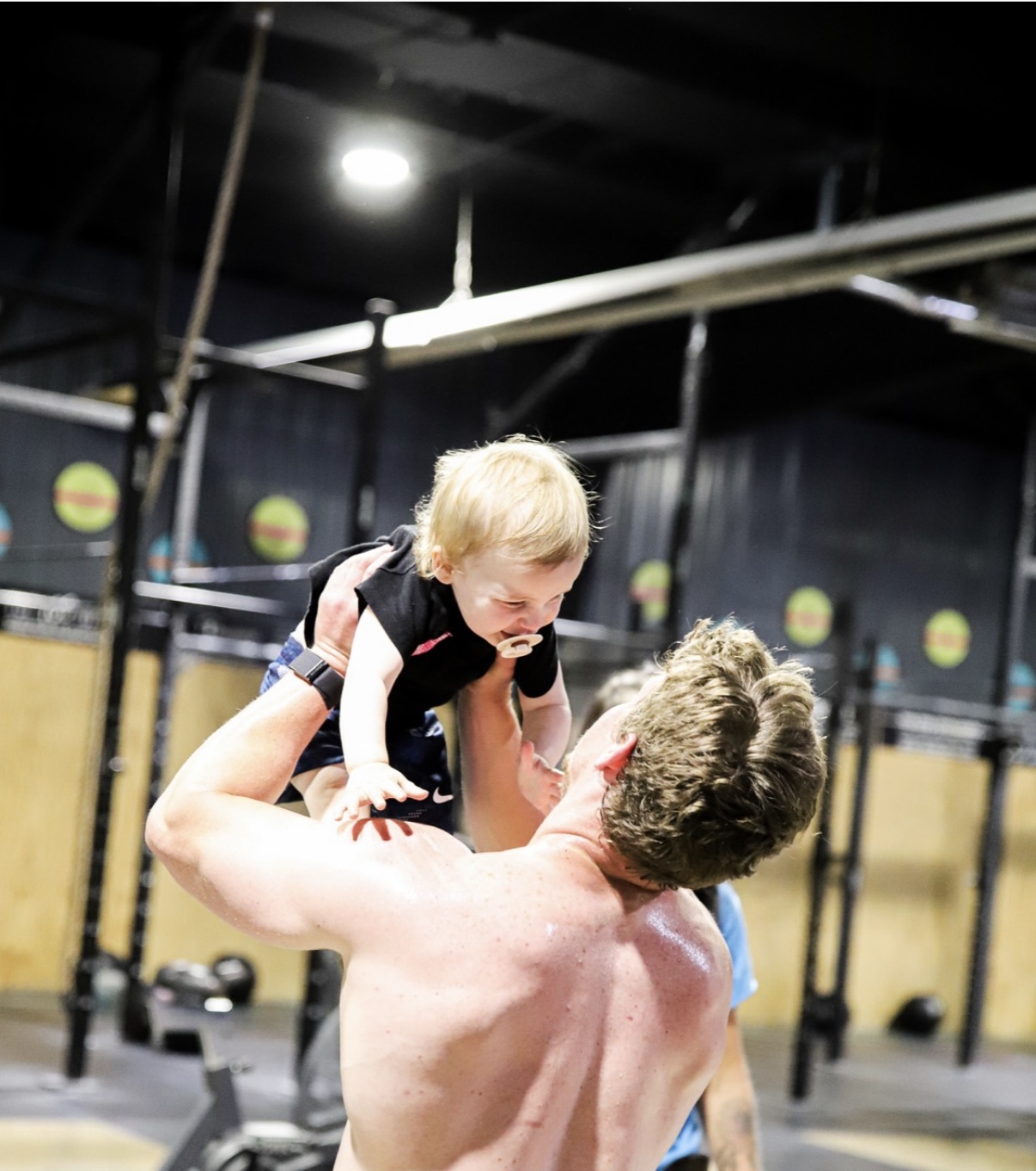 Coach Curt with his child in the gym